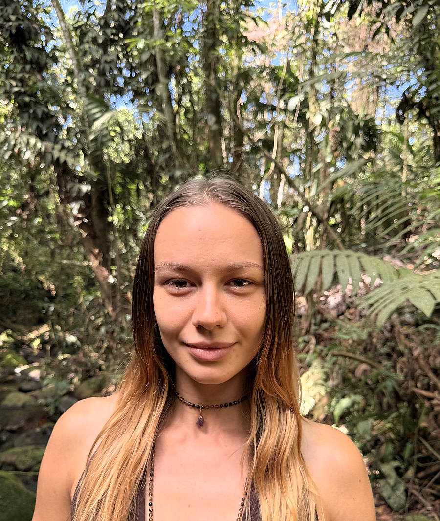 Skye standing in the jungle, looking directly at the camera with a soft, open expression.